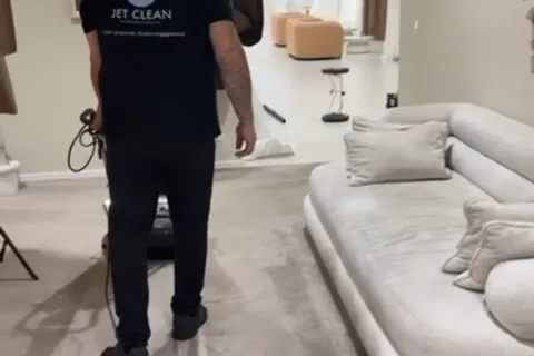 Agent Jet Clean nettoyant une moquette dans un salon